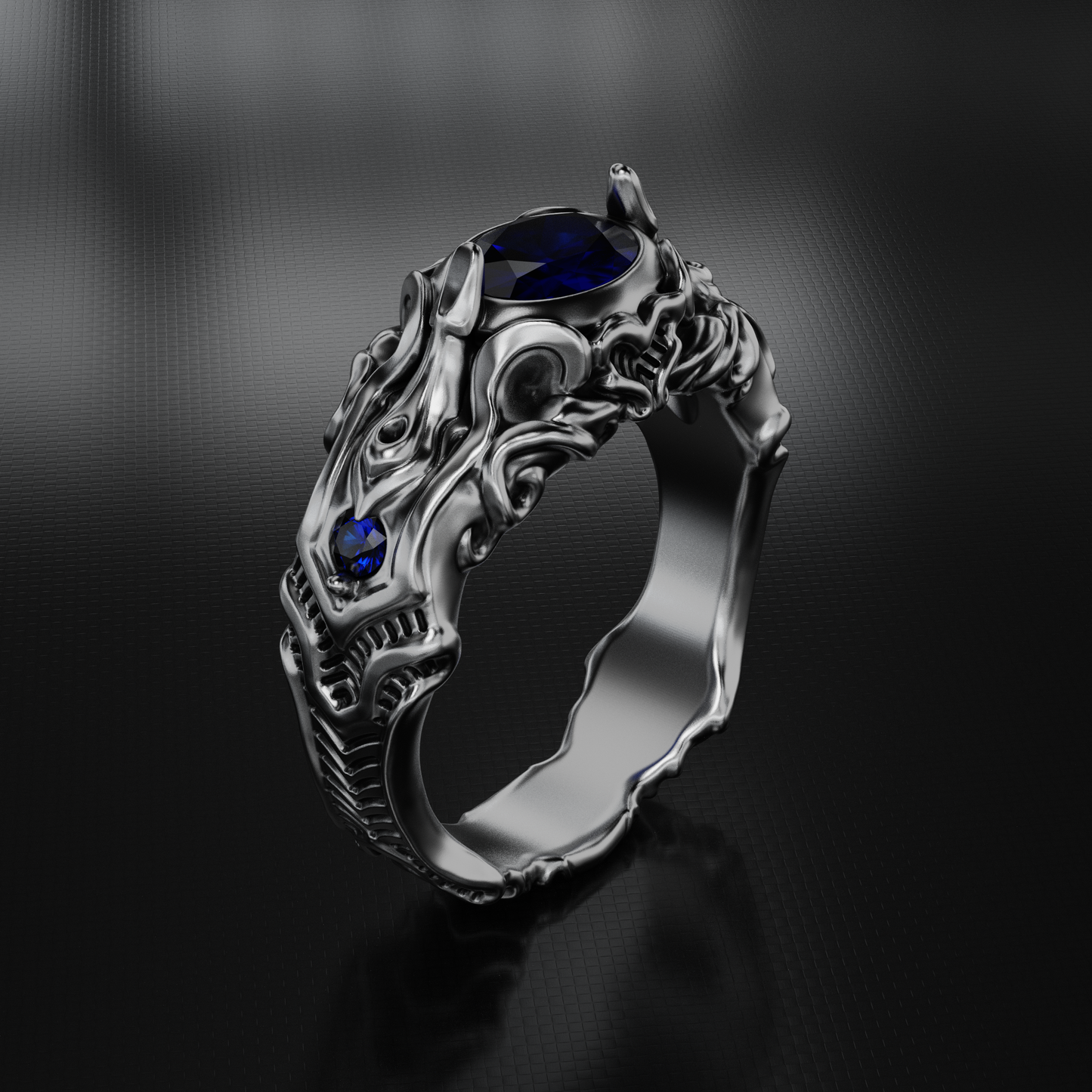 Silver ring with blue gemstones on a dark background